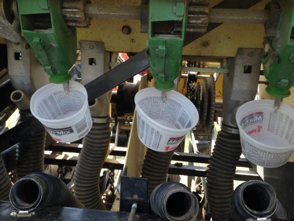 May 2015.  Wayne Schottler catching seed as part of calibrating his no-till drill near Froid MT